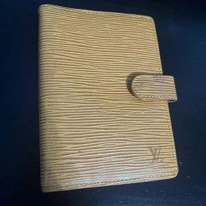 Louis Vuitton small agenda. With some peeling in the pockets.